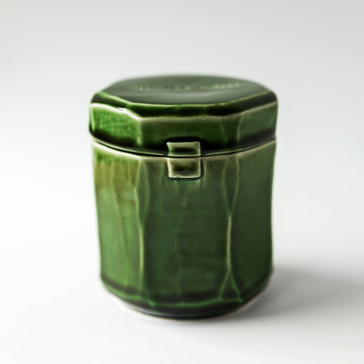 Grapefruit Cream 140 g candle in a handmade green ceramic vessel