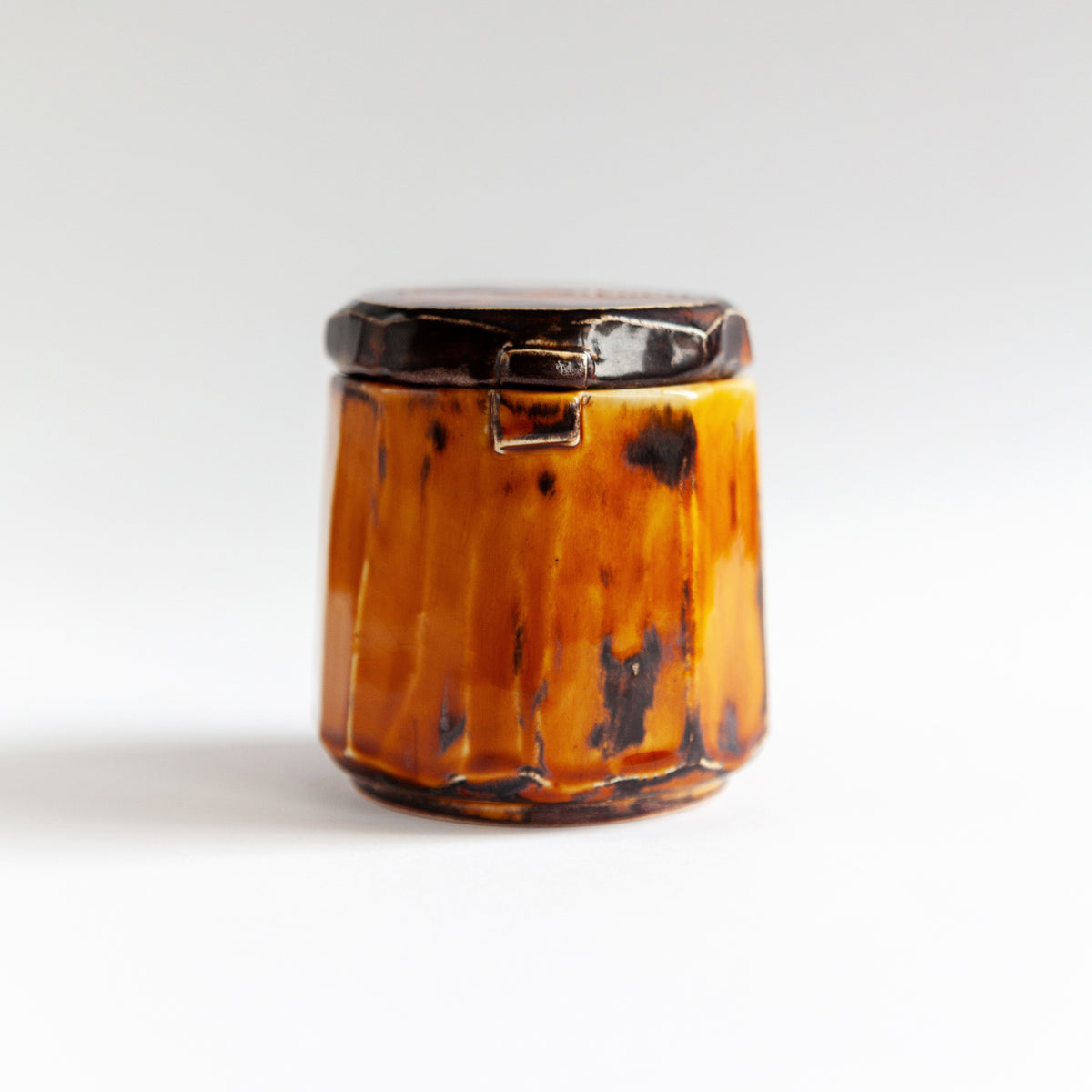 Vanilla Smoke 140 g candle in a handmade amber ceramic vessel