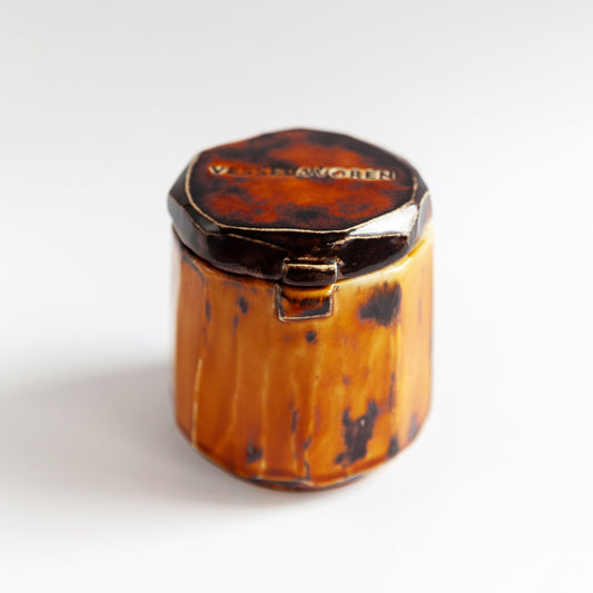 Vanilla Smoke 140 g candle in a handmade amber ceramic vessel